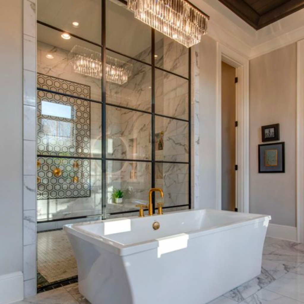Luxury bathroom remodel with updated fixtures, bathtub, lighting and tile. 